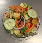 Dinner Salad · Fresh and crisp iceberg and romaine lettuce topped with tomato, cucumber, red onion, diced r...
