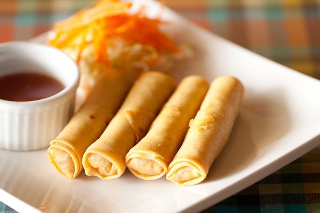 Thai Egg Rolls · Vegetarian deep fried spring rolls. Marinated in a black pepper and light soy sauce. Mixed with cabbage, carrot, glass noodles and wrapped in a spring rolls skin served with sweet chili sauce. Vegetarian.