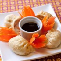Thai Dumpling · 6 pieces. Shrimp and pork mixed together then wrapped in pot sticker skin. Served with house...