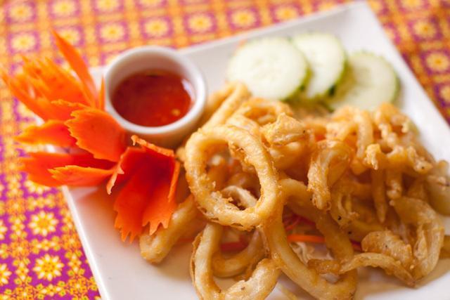 Crispy Calamari · Calamari marinated with special herbs, mixed in tapioca flour then fried to a golden brown. Served with chili sauce.