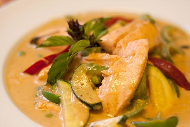 Salmon Curry · Medium green curry in coconut milk with salmon, bell peppers, zucchini, eggplants and Thai basil.
