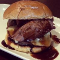 BarBQ Brisket Sandwich · Dry rubbed smoked brisket, pepper jack cheese, BBQ sauce and fried onion ring on a brioche b...