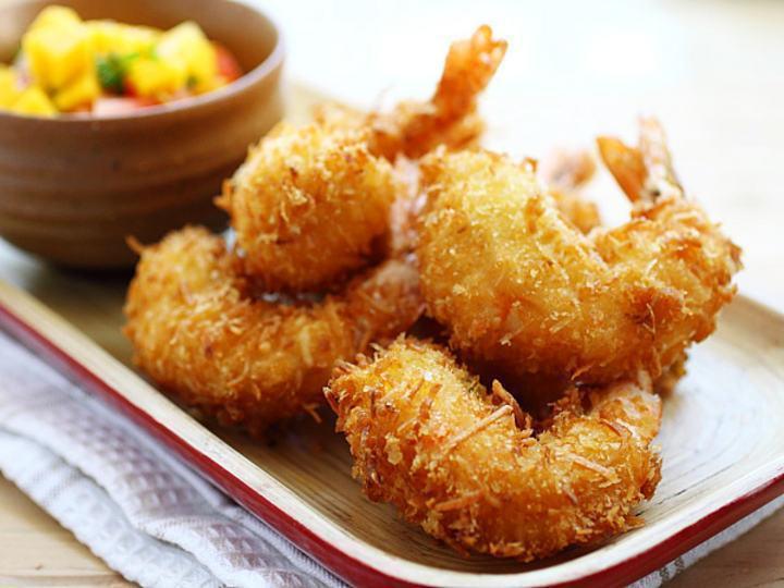 4. Coconut Prawns · 5 pieces flash fried black tiger shrimp dipped in coconut flakes. Served with Thai sweet chili sauce.