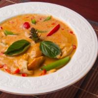 55. Red Curry with Rice · Coconut cream red curry, bamboo shoots, bell pepper and basil. All curries are medium spicy. 