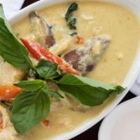 57. Green Curry · Green curry with coconut milk, eggplant, bell pepper, basil and bamboo shoots.