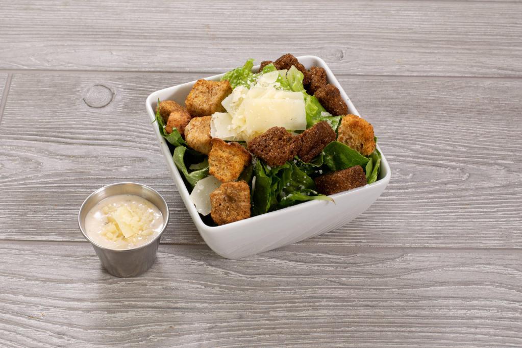 Caesar Salad · Traditional Caesar dressing, croutons and shaved Parmesan cheese.