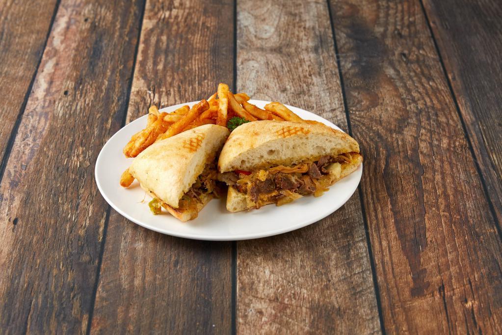 Cheesesteak Sandwich · Grilled chopped steak or chicken, caramelized onions, bell peppers, mustard, garlic butter and a melted 3 cheese blend on a delicious focaccia bread roll with fries or house salad.