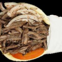 6. Steak Shawarma Pita · Marinated Angus beef broiled on a vertical skewer with onion, tomatoes and our garlic sauce.