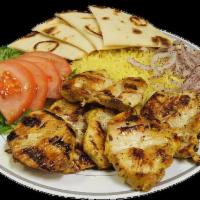 17. Chicken Souvlaki Plate · Marinated pieces of chicken breast flamed to perfection with lettuce, onion, tomatoes and tz...