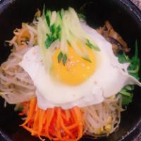 Bibim Bap · Eigth seasoned veggies, marinated beef and a fried egg over rice. Served with Korean spicy s...