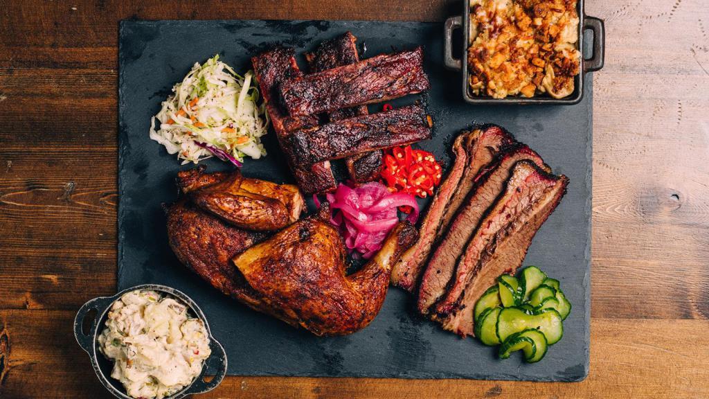 Family Meal · Meal includes 2 lbs. of meat, 2 qts. of sides, assorted pickled veggies, slaw, rolls, and BBQ Sauce. (feeds approximately 4 people)
