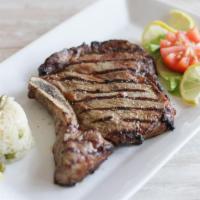 Grilled Rib Eye Steak · Prime steak cut. With lemon potatoes and spinach