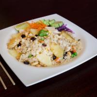 Pineapple Fried Rice · Stir fried rice with egg, pineapple, cashew nuts, raisins, peas and carrots with house sauce.