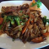 Pad Se-Ew Noodle · Stir fried wide rice noodles with egg, broccoli, carrots, onions, bok choy and a delicious s...