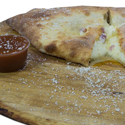 Hawaiian Calzone · Fresh dough, pineapple, ham, country sweet sauce, ricotta cheese, mozzarella and pecorino Romano cheese.