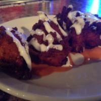 Buffalo Tots · House made tots infused with Buffalo chicken, blue cheese crumbles, cilantro and Cheddar Jac...