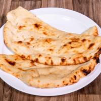 Naan · White flour flat dough baked in clay oven.