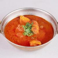 Chicken Curry · Chicken cooked in tomato and onion based curry sauce.