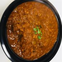 Goat Curry, not come with rice  · Goat cooked with onion gravy,ginger,garlic,tomato paste,indian spices ,thick gravy