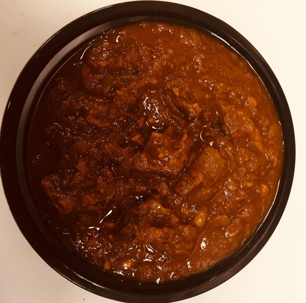 Goat Masala · 16 oz bowl cooked Goat bone in or bone less meat ,onion ginger,garlic and own spices,tomato paste,and gravy
