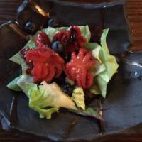 Octopus Salad · Mixed green salad with octopus and berries with citrus dressing.