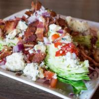 Wedge Salad · Iceberg lettuce served with creamy blue cheese dressing and crumbles, Applewood bacon, tomat...