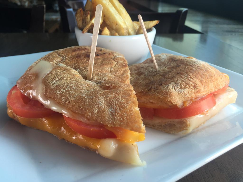 Grilled Cheese Sandwich · Cheddar, Swiss, spinach and tomato on sourdough. Served with choice of side.