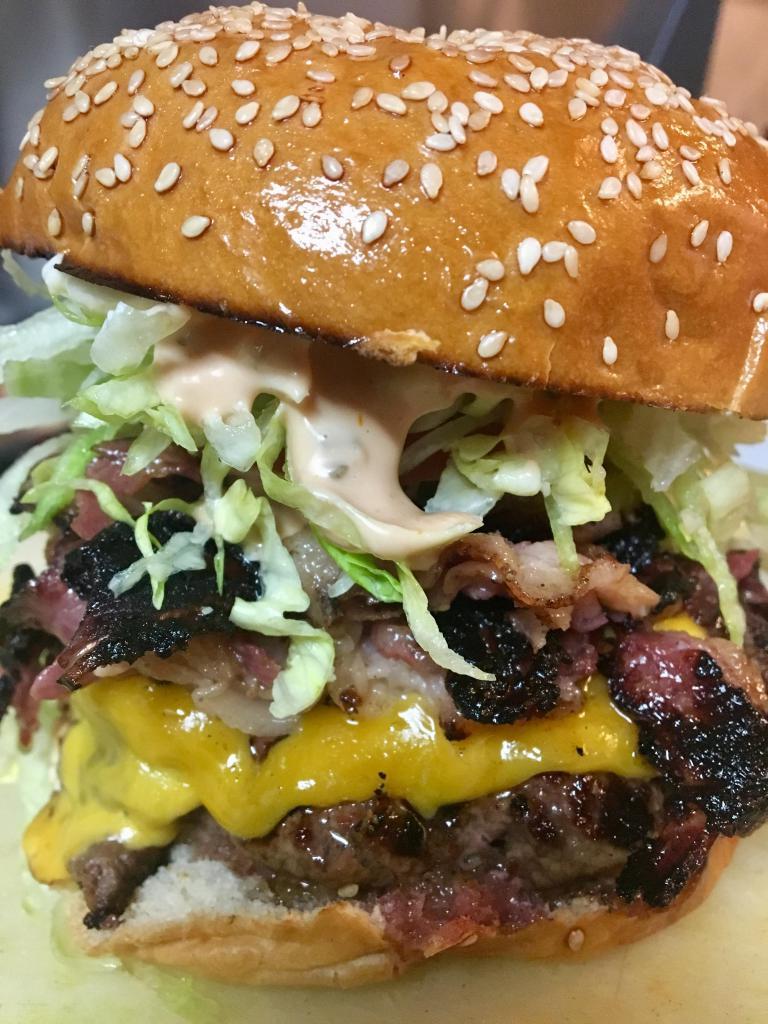 1/2 lb. Pastrami Burger · Huge premium Angus beef patty topped with Swiss cheese, pastrami, pickles and Thousand Island you won't believe it 'til you try it! Served with choice of side.