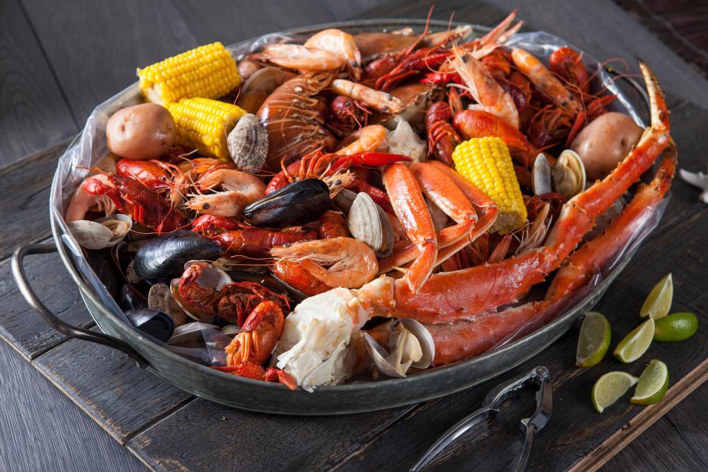 Mad Claw Family Bucket · King Crab (2-3 legs), Snow Crab (2 Clusters), Scallop, Lobster Tail (1), Shrimp (2 Lbs), Green Mussels, Black Mussels, Brown Clams, Crawfish, 8 corns, 8 potatoes and 2 sausages. (7-8 person) NO SUBSTITUTION