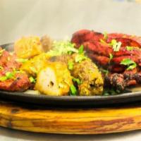 Mixed Grill · Assortment of chicken tikka tandoori chicken, shish kabab, tandoori shrimp, malai kabab. Ser...