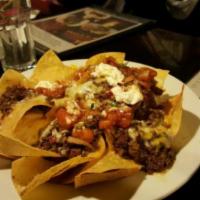 Chili Nachos · Corn tortillas loaded with cheese, topped with Mexican chili, jalapeno, sour cream and salsa.