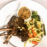 Herb Marinated Lamb Chops · Hand selected a pound finest grilled lamb chops served over mint peppercorn sauce. Served wi...