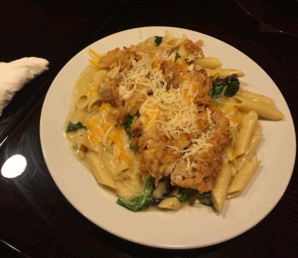 Chicken Parmesan Primavera · Spinach, onions and mushroom tossed with penne pasta in creamy cheese sauce topped with breaded chicken, Asiago and cheddar cheese.