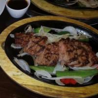 Steak Fajita · 1/2 pound of usda choice steak grilled and thinly sliced over grilled onions and peppers. Se...