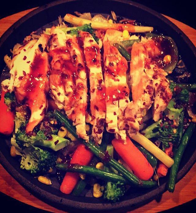 Grilled Chicken Sizzle · GRILLED CHICKEN THINLY SLICED PLACED OVER A MEDLEY OF STIR FRIED VEGETABLES AND RICE DRIZZLED WITH YOUR CHOICE OF KUNG PAO OR TANGY THAI SAUCE