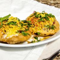 Kahsta Kachori · Whole wheat puffed ball blended with potato, tomato, onion and sprout topped with yogurt and...