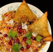 Samosa Chat · Samosa crushed and blended with garbanzo curry garnished with sweet and spicy sauce.