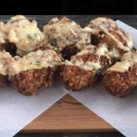 8 Pieces Loaded Tots · Hand shredded tots topped with mixed cheese, bacon and chives. Served with sour cream and qu...