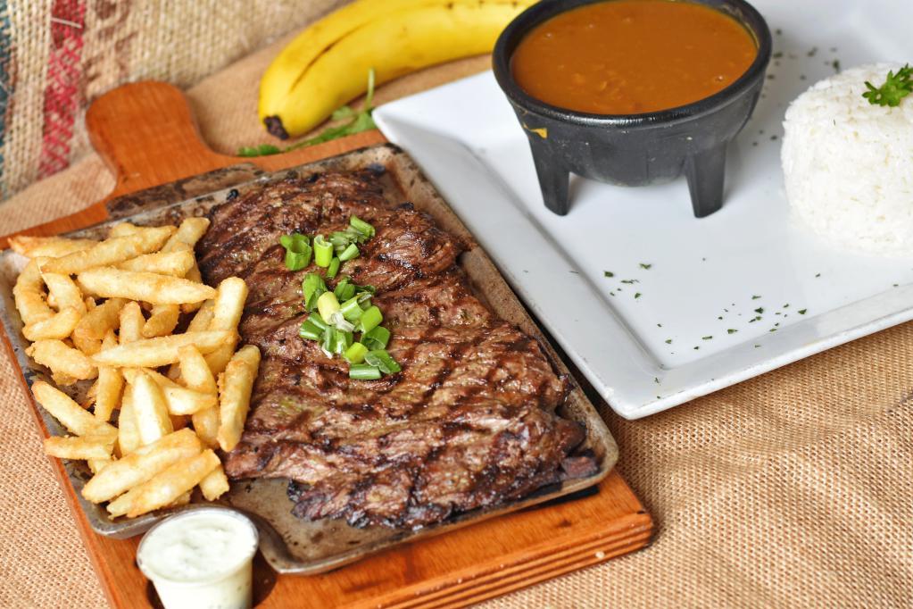 12. Carne Al Carbon con 3 acompanantes · Grilled or charbroiled Flap Meat steak.