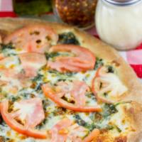Creamy Spinach Pizza · Heavy cream, mozzarella, spinach and tomato slices.