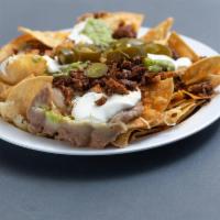 Super Nachos · Served with meat. Includes beans, cheese, sour cream, guacamole, jalapenos and pico de gallo.