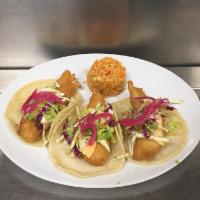Pescado Tacos · Negra Modelo beer-battered tilapia tacos, creamy chipotle mayo, and pickled red onions.