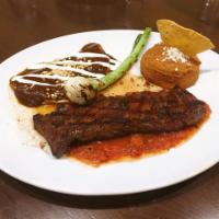 Carne Asada · Cilantro-marinated grilled skirt steak, an enchilada with black mole, pinto beans, molcajete...