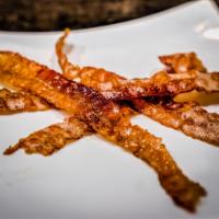 Bacon · Four slices of crispy bacon.