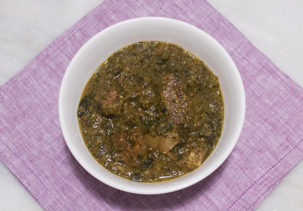 Saag Goat · Tender goat sauteed with fresh-chopped spinach and spices. Comes with basmati rice on the side.
