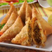Chicken Samosa · Patties stuffed with minced chicken, peas, onions and herbs deep fried.
