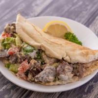 Lamb Kabob Pita Wrap · Charbroiled and marinated lamb with tomatoes, onions, hummus spread, and tzatziki sauce insi...