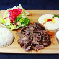 11. Lamb and Beef Gyro Plate · Slow cooked, thin sliced, marinated lamb and beef. Served with rice, salad, pita bread and h...