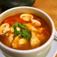 Tom Yum Soup · A well-known Thai hot and sour soup with roasted chili, lime leaves, lime juice, mushrooms, ...