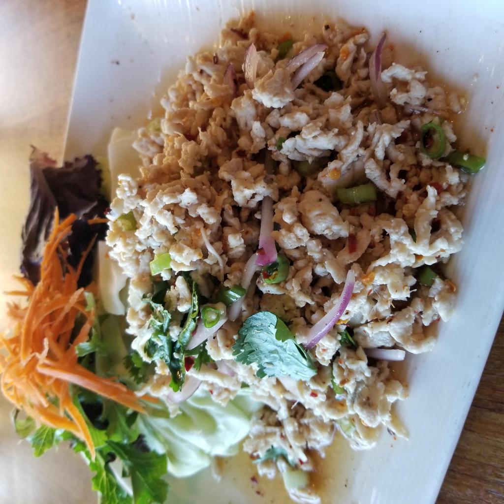 Larb Gai Salad · Fully cooked, finely ground chicken mixed with lime juice and hot chili, served with fresh cabbage and carrots.